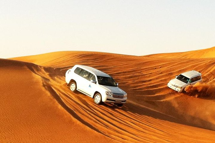Experience the vast dunes of Dubai as you embark on an exhilarating drive capturing stunning sunset views and creating unforgettable memories in the heart of the desert.